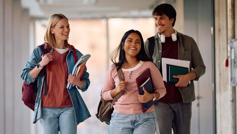 College Students Walking Down a School Hallway