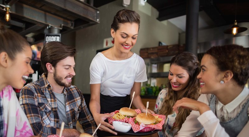 Waitress Serving Burgers at a Restaurant