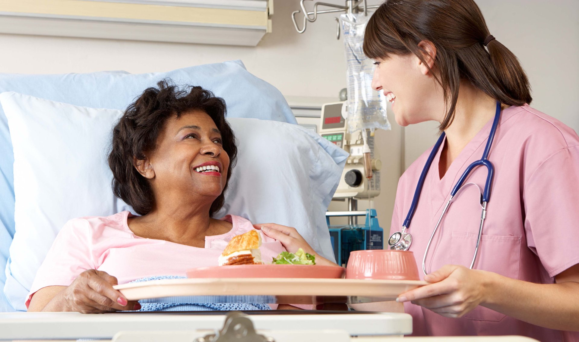 Nurse Serving Food to a Patient